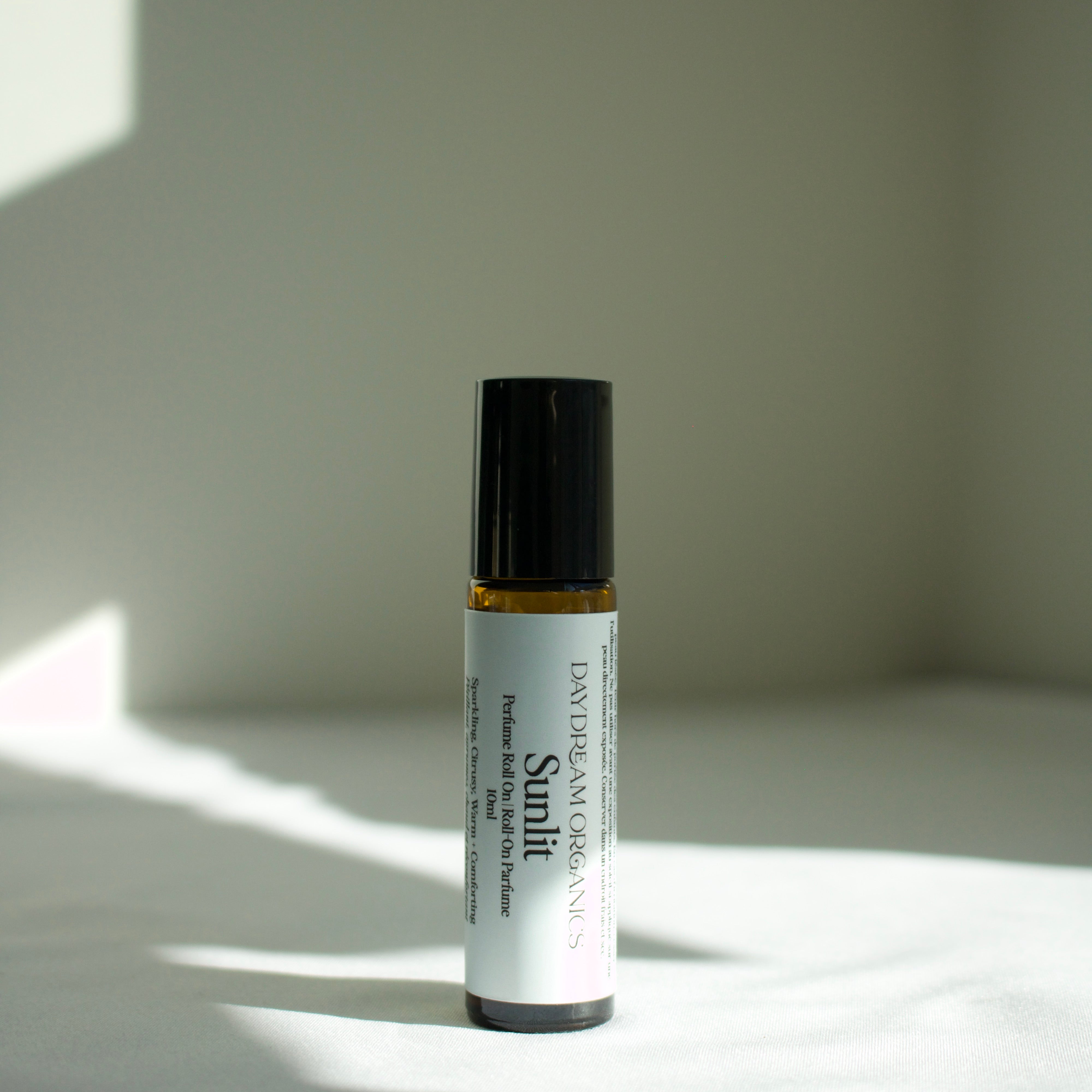 Our Sunlit perfume roll-on is bright, warm and softly grounding. Sunlit captures the feeling of golden light on skin with notes of sparkling citrus and smooth warmth. Sunlit is a balanced scent that is both uplifting and deeply comforting - like liquid sunshine.