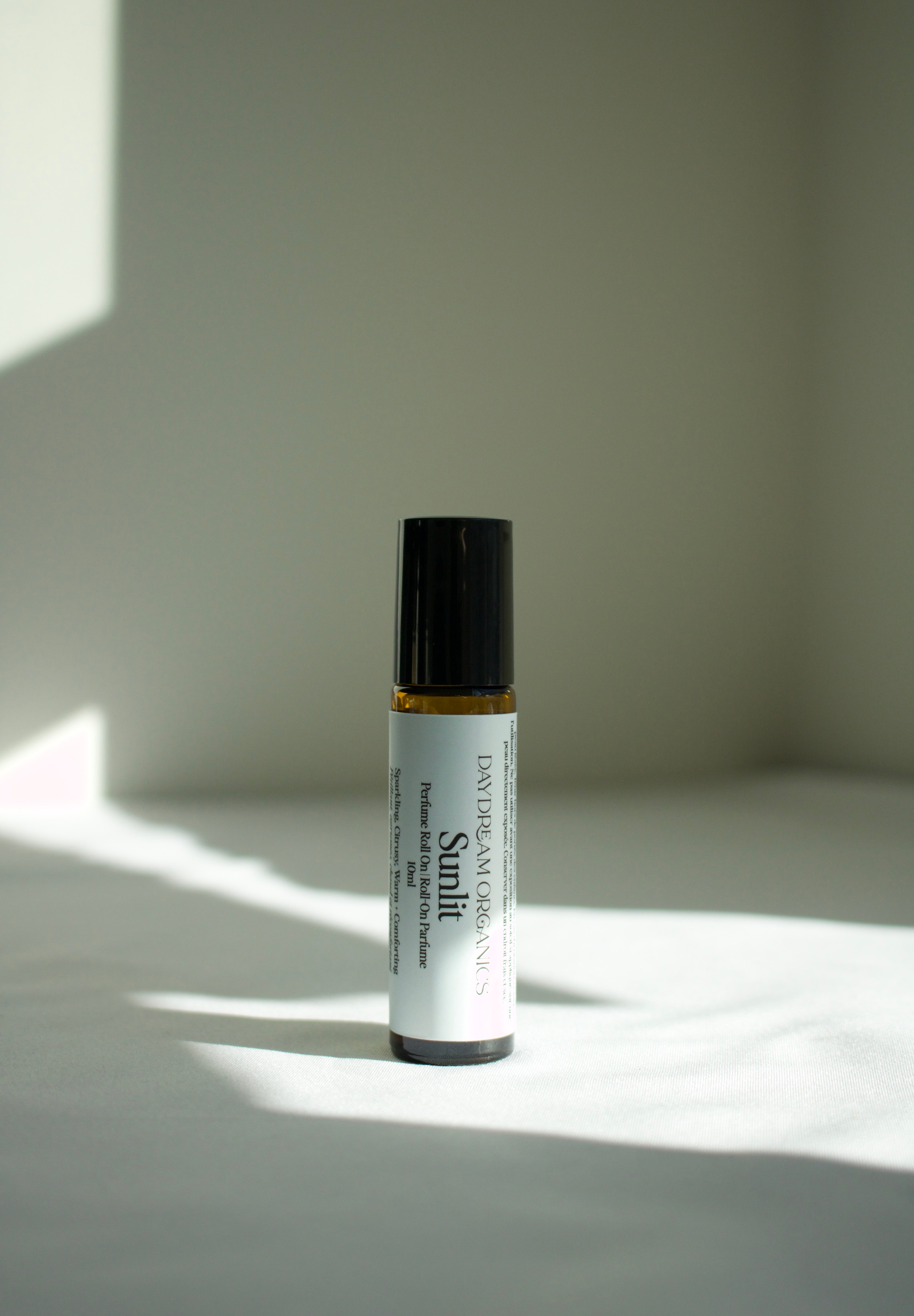 Our Sunlit perfume roll-on is bright, warm and softly grounding. Sunlit captures the feeling of golden light on skin with notes of sparkling citrus and smooth warmth. Sunlit is a balanced scent that is both uplifting and deeply comforting - like liquid sunshine.